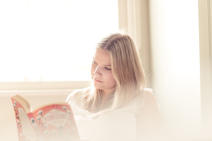 A child reading a book in soft sunlight